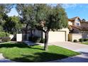 Cute stucco home with a two car garage and manicured lawn at 7904 E Pepper Tree Ln, Scottsdale, AZ 85250