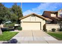 Tan stucco home with a two car garage and driveway at 7904 E Pepper Tree Ln, Scottsdale, AZ 85250