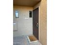 Condo entrance with a brown metal door and welcome mat at 7950 E Starlight Way # 142, Scottsdale, AZ 85250