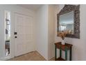 Bright entryway with a white door, decorative mirror, and a small side table at 8119 E San Miguel Ave, Scottsdale, AZ 85250