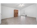 Spacious living area featuring tile flooring, neutral walls, ceiling fan, and access to patio at 8549 E Carol Ave, Mesa, AZ 85208