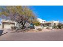 Beautiful stucco home with a large driveway and mature desert landscaping at 9570 E Via Montoya Dr, Scottsdale, AZ 85255