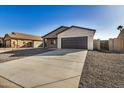 New construction home featuring a two-car garage at 10671 W Arivaca Dr, Arizona City, AZ 85123