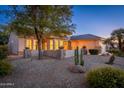 Well-maintained house with a landscaped yard, featuring stone accents and desert plants at 15583 W Big Sky Dr, Surprise, AZ 85374