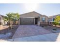 House exterior showcasing a two-car garage and well-maintained landscaping at 19959 W Rancho Dr, Litchfield Park, AZ 85340