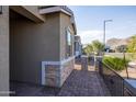 Brick walkway leads to the entrance of the house, with stone accents at 19959 W Rancho Dr, Litchfield Park, AZ 85340
