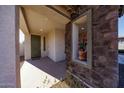Front entry with stonework and a decorative planter at 20487 W Minnezona Ave, Buckeye, AZ 85396
