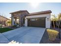 Single-story home with stone accents and a two-car garage at 20487 W Minnezona Ave, Buckeye, AZ 85396