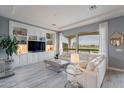 Bright living room with built-in shelving, plush seating, and a view of the golf course at 36925 N Stoneware Dr, Queen Creek, AZ 85140
