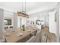Bright dining room features a wood table and access to the back patio at 39015 N 6Th Dr, Phoenix, AZ 85086