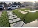 Artificial turf lawn with a stone walkway and lighting at 4016 W Wagon Wheel Dr, Phoenix, AZ 85051