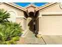 Front entry of the house with a walkway and a two-car garage at 6601 S Oakmont Dr, Chandler, AZ 85249