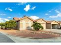 View of house from the street showcasing desert landscaping and two-car garage at 6601 S Oakmont Dr, Chandler, AZ 85249