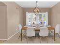Elegant dining room with a chandelier and view of the pool at 9452 S 51St St, Phoenix, AZ 85044