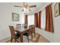 Charming dining area with a wood table and four chairs, plus a southwestern rug at 10642 W Mohawk Ln, Peoria, AZ 85382