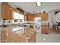 Well-equipped kitchen with granite countertops and ample wood cabinetry at 10642 W Mohawk Ln, Peoria, AZ 85382