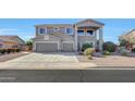 Two-story house with gray exterior, two-car garage, and well-manicured landscaping at 11224 N 152Nd Ln, Surprise, AZ 85379