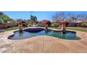 Inviting kidney-shaped pool with a surrounding patio and lush landscaping at 11224 N 152Nd Ln, Surprise, AZ 85379