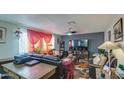 Spacious living room with dark leather furniture and a fireplace at 11451 E Broadway Rd, Mesa, AZ 85208