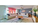 Bright living room featuring a large sectional sofa, modern rug, and stylish decor at 11451 E Broadway Rd, Mesa, AZ 85208