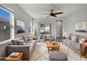 Bright living room featuring two sofas, a coffee table, and large windows at 11468 E Sunflower Ln, Florence, AZ 85132