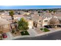 Aerial view of two-story house with solar panels, pool, and playground in backyard at 11935 N 148Th Ave, Surprise, AZ 85379