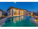 Inviting backyard oasis: sparkling pool with fire pit and patio at 12007 W Creosote Dr, Peoria, AZ 85383