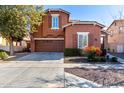 Two-story house with brown exterior, two-car garage, and landscaped front yard at 13627 N 150Th Ave, Surprise, AZ 85379