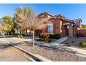 Two-story house with brown exterior, two-car garage, and landscaped front yard at 13627 N 150Th Ave, Surprise, AZ 85379