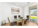 Dining area with glass table, four chairs, and access to backyard at 18443 W Villa Chula Ln, Surprise, AZ 85387