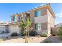 Two-story house with neutral siding and landscaping, showcasing curb appeal at 18443 W Villa Chula Ln, Surprise, AZ 85387