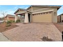 Attractive curb appeal with a brick driveway and desert landscaping at 19929 W Roma Ave, Litchfield Park, AZ 85340