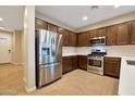 Modern kitchen with stainless steel appliances and wood cabinets at 19929 W Roma Ave, Litchfield Park, AZ 85340