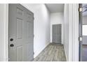 Interior hallway with gray doors and wood-look tile floor at 205 E Jackson Ave, Buckeye, AZ 85326