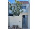 Light-colored stucco building with a gated entry and a tree with yellow fruit at 2524 S El Paradiso -- # 106, Mesa, AZ 85202