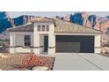 Single-story home with a two-car garage and desert landscaping at 25437 W Graham Trl, Buckeye, AZ 85326