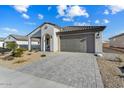 Newly built home with a gray garage door and well-manicured landscaping at 26330 W Kimberly Way, Buckeye, AZ 85396