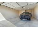 Spacious garage with overhead door and ample space for a vehicle at 26330 W Kimberly Way, Buckeye, AZ 85396