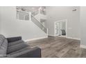 Living room with gray couch and access to home gym at 28225 N 65Th Ln, Phoenix, AZ 85083