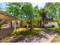 Ranch house with carport, mature trees, and brick walkway at 2825 N 33Rd Pl, Phoenix, AZ 85008