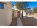 Home entrance with red door and walkway at 29798 N 121St Dr, Peoria, AZ 85383