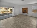 Bright living room with sliding glass doors leading to the backyard at 30734 W Clarendon Ave, Buckeye, AZ 85396