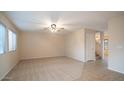 Living room with carpeted floors and neutral wall colors at 30788 N Whirlaway Trl, San Tan Valley, AZ 85143