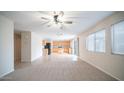 Spacious living room with carpeted floors and a view of the kitchen at 30788 N Whirlaway Trl, San Tan Valley, AZ 85143