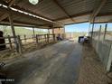 Inside a well-maintained barn with metal fencing, ample space, and practical layout for various farm activities at 42213 N 3Rd St, Phoenix, AZ 85086