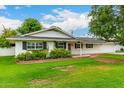 Landscaped front yard of this single-story home featuring a well-manicured lawn and shuttered windows at 4525 E Calle Ventura --, Phoenix, AZ 85018