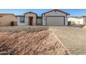 Modern home exterior with a two-car garage and paver driveway at 6208 S Eagle Pass Rd, Gold Canyon, AZ 85118