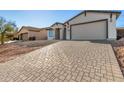 New construction home with a two-car garage and paver driveway at 6208 S Eagle Pass Rd, Gold Canyon, AZ 85118