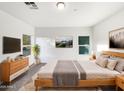 Bright and airy main bedroom with wood furniture and large windows at 6638 S 6Th Ave, Phoenix, AZ 85041