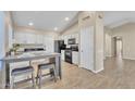 Eat-in kitchen with breakfast bar and wood-look flooring at 710 S Monterey St, Gilbert, AZ 85233